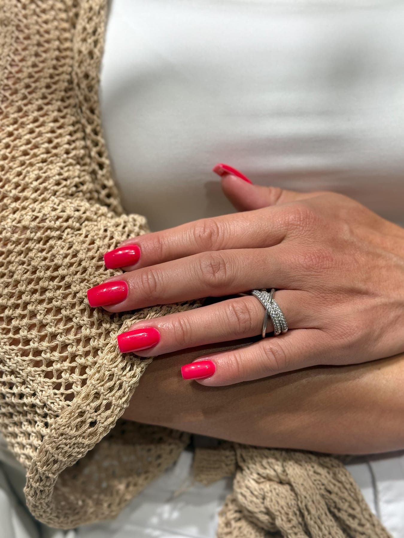 Red nails, knitwear and a silver ring
